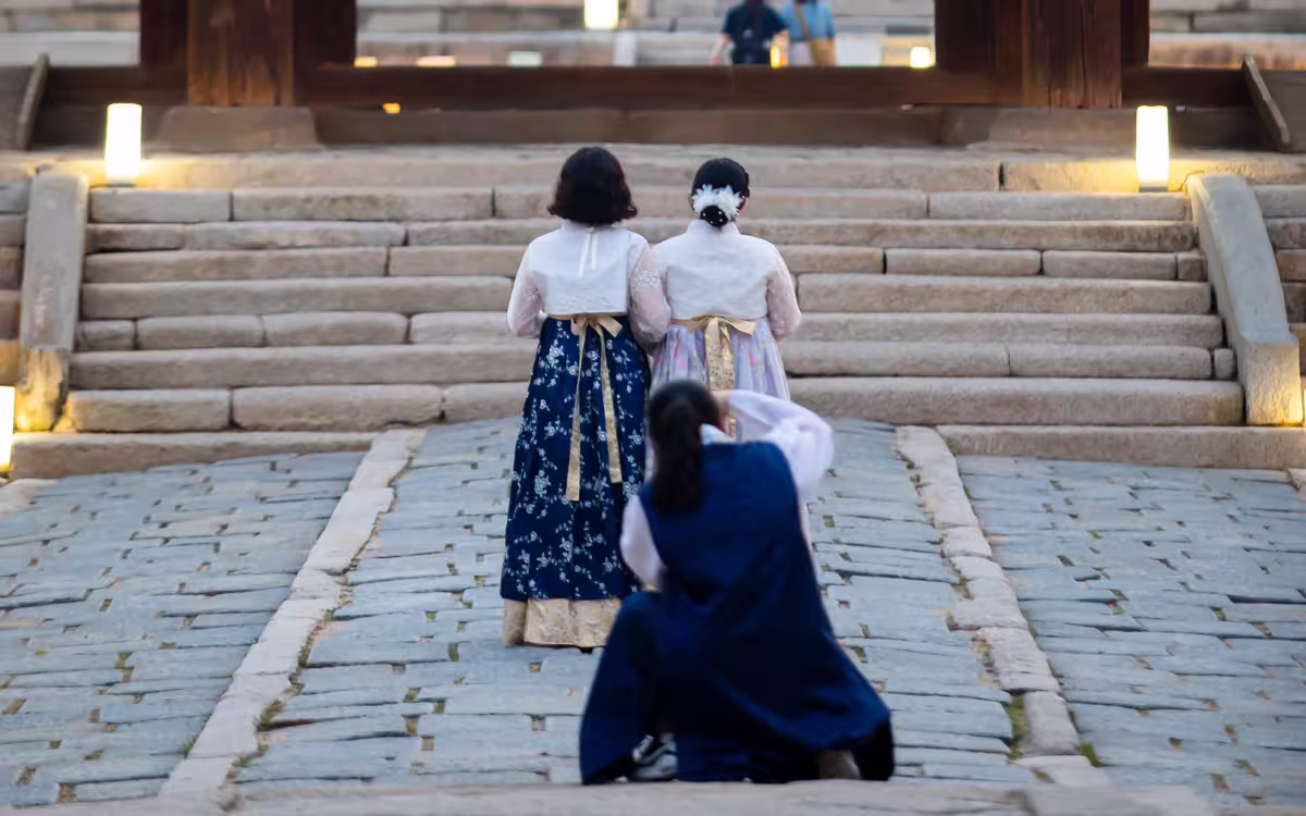 Turistas vestidos con hanbok tradicional caminando por el Palacio Changgyeonggung, Seúl